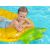 Smiling boy on pineapple inflatable pool float