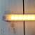 Close-up of the white motion sensor LED light bar with visible LEDs