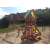 Woodlit Sunnydale wooden playground with slide, swings, and picnic table, green and brown