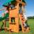 Woodlit Somerset playset with a child climbing the climbing wall