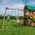 Woodlit Somerset playset with children swinging on the swings