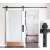 Timeless Tools black sliding barn door hardware kit installed on a white door