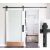 Timeless Tools black sliding barn door hardware kit installed on a white door