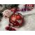 Springos red Christmas ornament with white Christmas tree and snowflake design in festive setting