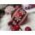Springos red Christmas ornament with white snowflake design in festive setting