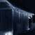 Springos 500 LED icicle lights decorating a house exterior at night