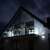 Springos 500 LED icicle lights decorating a house exterior at night, with a balcony