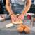 Woman using Springos silicone baking mat to knead dough in a kitchen