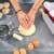 Woman using Springos silicone baking mat to knead dough in a kitchen