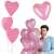 Man holding a bunch of Springos pink heart balloons