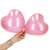 Woman holding two Springos pink heart balloons