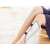 Wireless electric muscle stimulator, white-gray, on a woman's leg