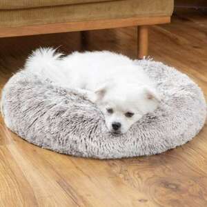 Grey fluffy dog bed with raised edges, a small white dog sleeping in it - Iso Trade