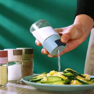 Glass spice shaker with blue lid, dispensing salt onto a plate of food - Spice Rack