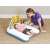 Bestway inflatable baby changing mat with rainbow arch and hanging toys, used by a mother on the floor