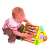 Child playing with a wooden activity center with letters, numbers, and shapes