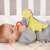 Fehn musical dinosaur toy for babies, yellow plush dinosaur with a red ring