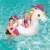 Child riding a Bestway inflatable unicorn pool float, rainbow design, in a swimming pool