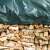 Green tarp covering a stack of firewood