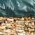 Black tarpaulin covering a stack of firewood