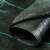 Agroszövet Fekete PPHA weed barrier fabric, black polypropylene fabric with green stripes, rolled up