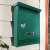 Timeless Tools green metal mailbox mounted on a wall