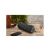 MUSE M-780 BT black Bluetooth speaker on wooden surface in outdoor setting