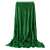 Springos green plush blanket with gold dots, draped over a chair