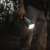 Person using Nebo Davinci 18000 flashlight in the forest