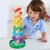 Дете играе с дървена кула за мрамор в цветовете на дъгата Tooky Toy