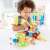 Child playing with Hape Basic Builder Set wooden toy, a colorful construction set with screws, nuts, and tools