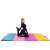 Woman stretching on Springos foldable exercise mat, colorful gym mat for flexibility