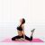 Woman stretching on Springos pink folding gymnastics mat in bright room