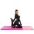 Woman stretching on Springos pink folding gymnastics mat