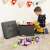 Child playing with toys on the floor, using the Songmics storage ottoman as a seat