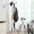 Black metal coat rack with 12 hooks, 182 cm tall, in a living room setting
