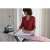 Woman ironing a white shirt on a Vileda DIAMOND M plus ironing board with a steam iron