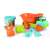 Green and orange dump truck with a bucket, shovel, rake, and two molds for sand play