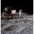 Astronaut planting the American flag on the moon