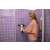 Woman using Kärcher WV 5 Plus N window vacuum cleaner to clean a shower door