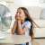 Girl enjoying the cool air from a fan
