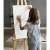 Child using a wooden easel to paint