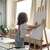 Child using a wooden easel to paint