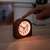 Navaris analog wooden alarm clock with light turned on