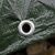 Close-up of a metal eyelet on a green waterproof tarp