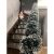Ruhhy Christmas garland decorating a staircase with a doll
