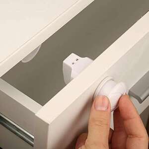 BabyJem magnetic cabinet lock installed on a white drawer, preventing it from opening - Baby Safety Lock