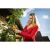 Woman using Riwall PRO RAP 3020i cordless pruning shears in garden