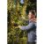 Man using Riwall PRO RAP 3020i cordless pruning shears to trim tree branches