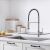 Timeless Tools kitchen faucet with flexible hose and pull-down sprayer in modern kitchen setting